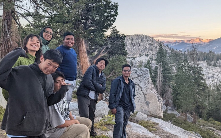 a group of students pose for a photo in the high sierra while on a backpacking trip with outward bound